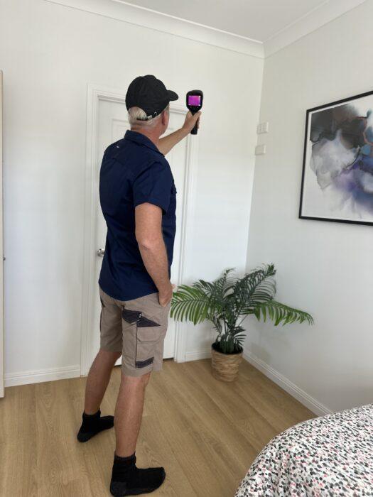 Man using a thermal camera for a building inspection 