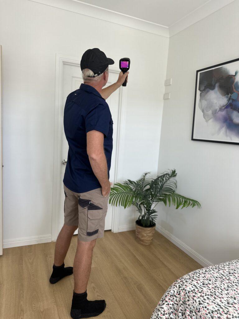 Stuart Slater using a thermal camera for a building inspection